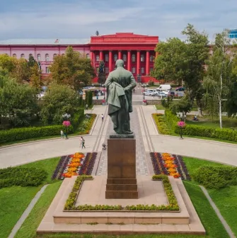 Monument to Taras Shevchenko and the red building of the university in Kyiv