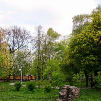 A green lawn with a stone sculpture at Volodymyr's Hill in Kyiv