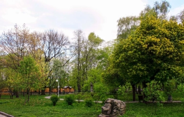 A green lawn with a stone sculpture at Volodymyr's Hill in Kyiv