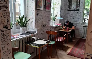 OG Burger in Kyiv - interior with graffiti walls and small tables