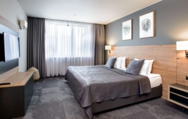 Superior room at Favor Park Hotel in Kyiv with a king-size bed