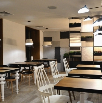 Honey in Kyiv - dining room with large cone lamps and plants