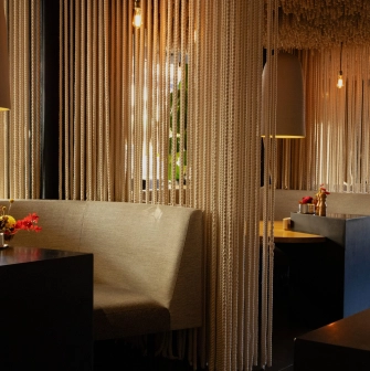 Restaurant Odesa - dining booths separated by ceiling-to-floor rope curtains