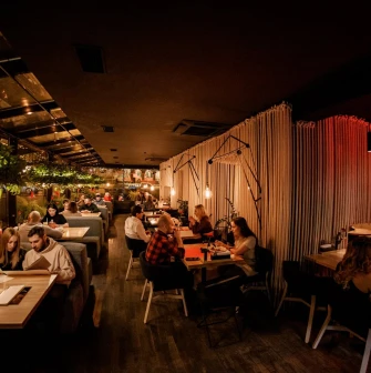 Restaurant Odesa - dark interior with dining guests and rope partitions