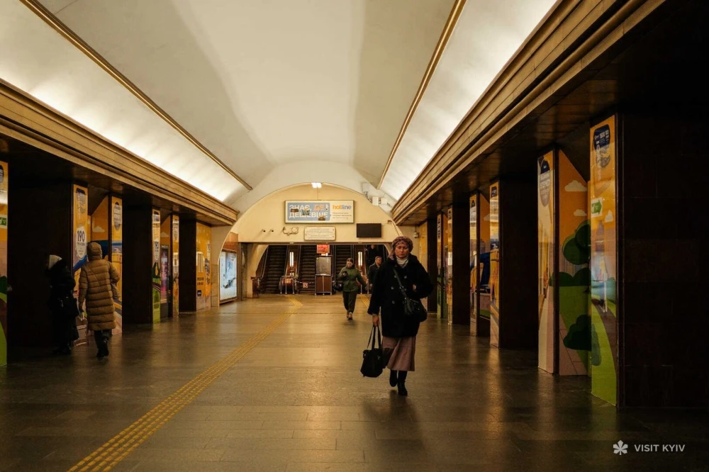 Spacious interior of an underground Kyiv metro station with people