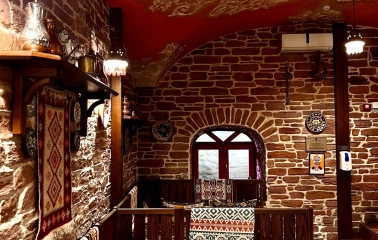 Sofra in Kyiv - dining area with brick walls, wooden seats and patterned textiles