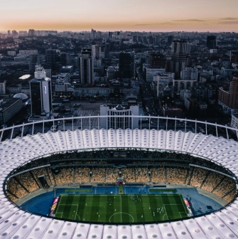 NSC Olimpiyskiy in Kyiv - stunning aerial evening view looking down into the illuminated stadium bowl
