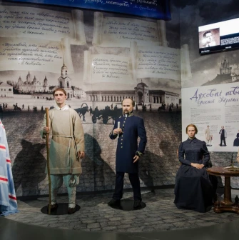Muzei Stanovlennia Ukrainskoi Natsii in Kyiv - lifelike wax figures of prominent 19th-century Ukrainian intellectuals standing together against a background of poetic quotes