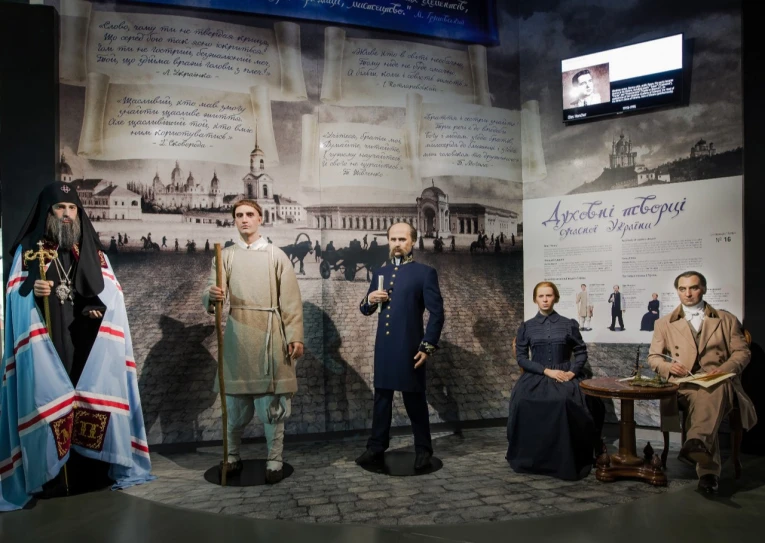 Muzei Stanovlennia Ukrainskoi Natsii in Kyiv - lifelike wax figures of prominent 19th-century Ukrainian intellectuals standing together against a background of poetic quotes