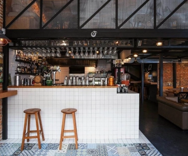 True Burger Bar - long bar counter displaying drinks and multiple beer taps