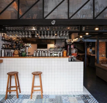 True Burger Bar - long bar counter displaying drinks and multiple beer taps