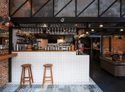 True Burger Bar - long bar counter displaying drinks and multiple beer taps