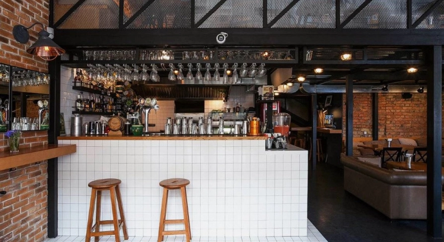 True Burger Bar - long bar counter displaying drinks and multiple beer taps