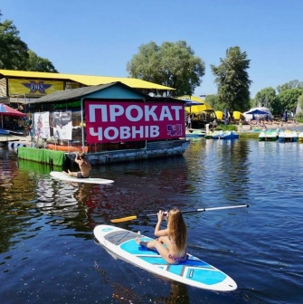 Muromets park - boat rental station on the water with people paddleboarding and kayaking near the pier