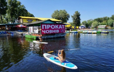 Muromets park - boat rental station on the water with people paddleboarding and kayaking near the pier