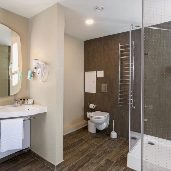 Ibis Railway Station in Kyiv - bathroom with shower stall and large mirror