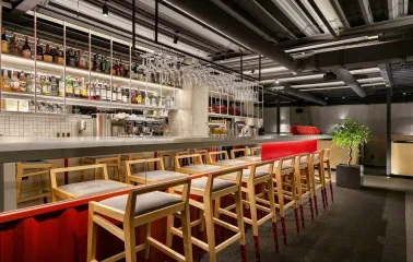 Fatum - modern bar counter with bottles and wooden stools