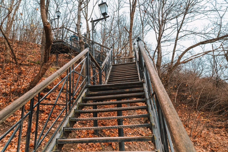 Volodymyrska Hill in Kyiv - metal stairs leading up the autumn slope to the Castle Hill