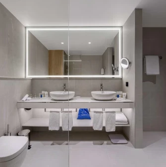 Radisson Blu - modern hotel bathroom with a bathtub and glass shower