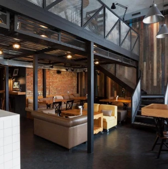 True Burger Bar - industrial style interior with exposed brick and varied comfortable seating