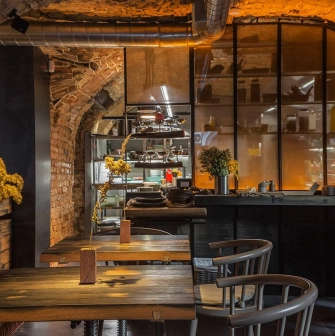 Winbar - long table set for dining with hanging lighting and contemporary artwork