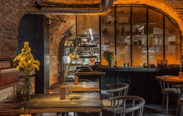 Winbar - long table set for dining with hanging lighting and contemporary artwork