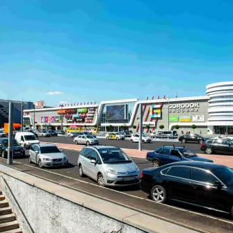 Gorodok Gallery in Kyiv - exterior view of the shopping mall building and busy street traffic