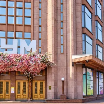 Spring decoration of the entrance to TSUM Kyiv with flowering decorative trees