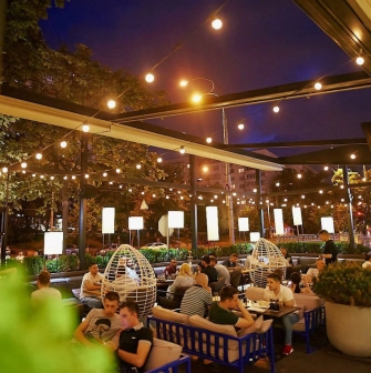 Par Bar - evening terrace with guests under string lights