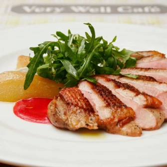Restaurant Very Well Cafe - close-up view of a steak dish with potato wedges and fresh herbs