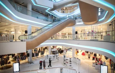 Modern interior of TSUM Kyiv with escalators and shopping areas