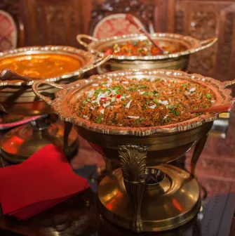 Indian cuisine dishes in copper bowls at restaurantHimalaya
