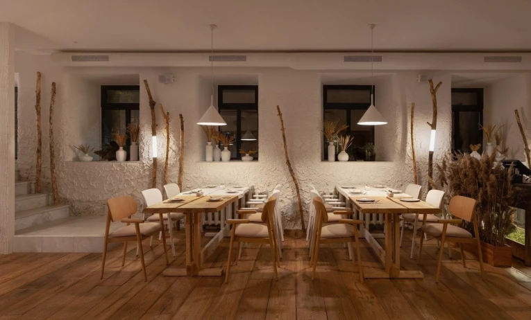 Restaurant 100 Rokiv Tomu Vpered - cozy tables near white textured walls and dark windows