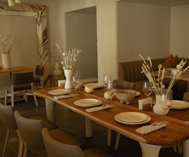 Restaurant Odesa - spacious dining room with a large wooden table set for a meal