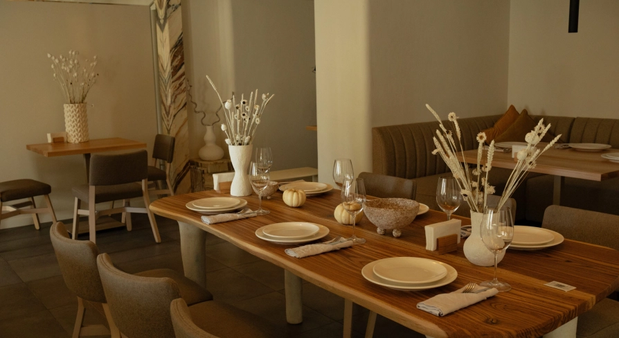 Restaurant Odesa - spacious dining room with a large wooden table set for a meal