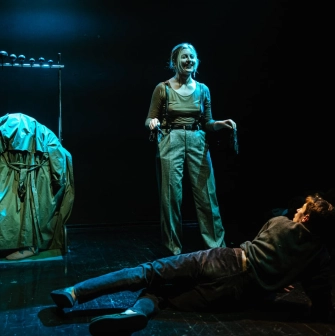 Molodyi Teatr in Kyiv - emotional stage performance with a smiling actress standing over an actor lying on the floor