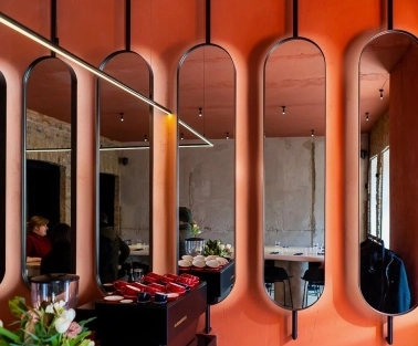 Designer mirror wall decoration at Pure & Naive restaurant in Kyiv with orange interior