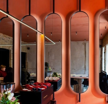 Designer mirror wall decoration at Pure & Naive restaurant in Kyiv with orange interior