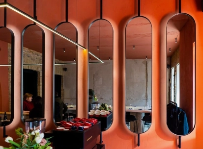 Designer mirror wall decoration at Pure & Naive restaurant in Kyiv with orange interior