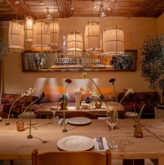 Seliam in Kyiv - cozy dining area with lights and flowers