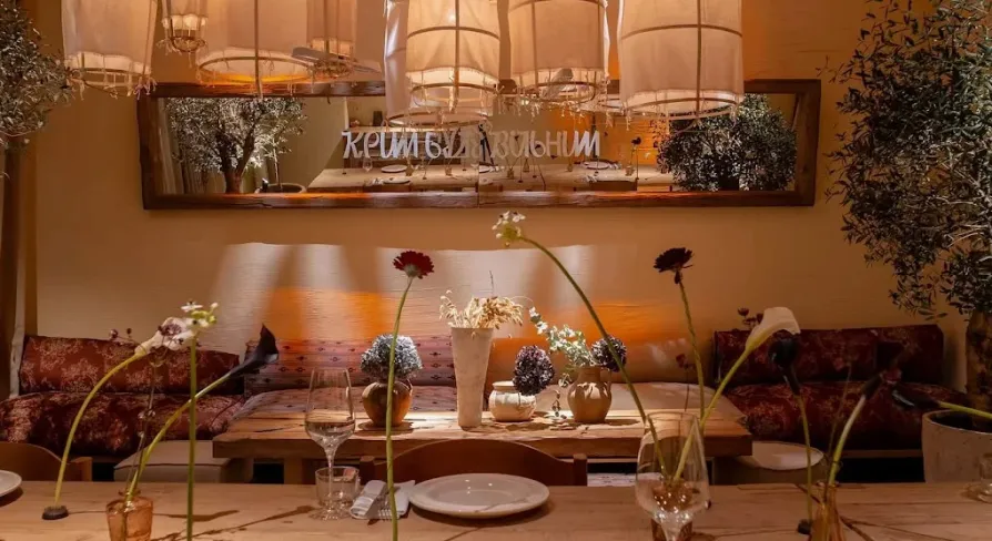 Seliam in Kyiv - cozy dining area with lights and flowers