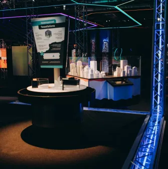 Museum of Mathematics Kuboid in Kyiv - modern interactive exhibit about tessellations featuring white architectural models and neon lighting in a dark museum hall