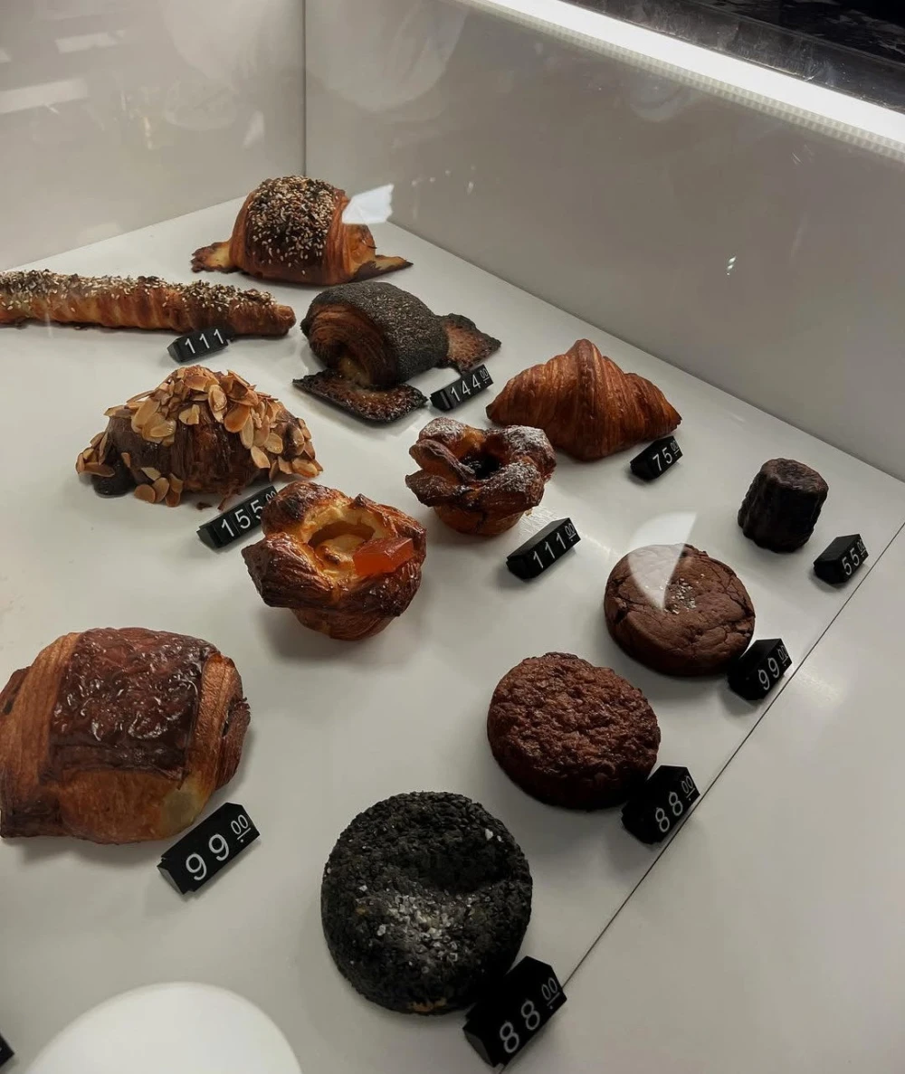 Spelta - counter display of various fresh baked goods including bread and pastries