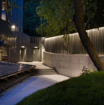 Teatr na Podoli in Kyiv - atmospheric outdoor courtyard with a concrete path and stairs illuminated by soft linear lights at night