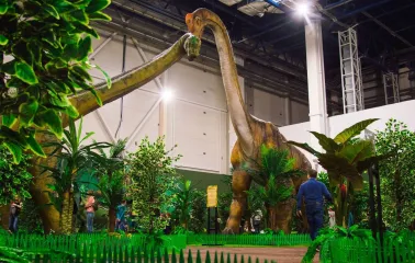 Giant animatronic dinosaur among artificial jungles in Lavina Dinopark