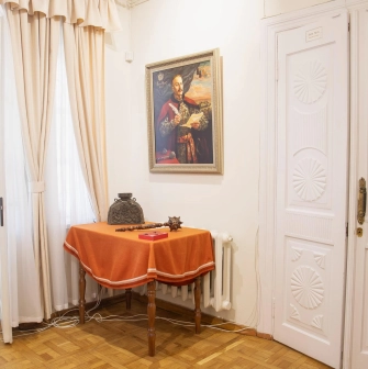 Muzei Hetmanstva in Kyiv - historic interior corner featuring a traditional Cossack mace resting on a table beneath a painted portrait of a Hetman