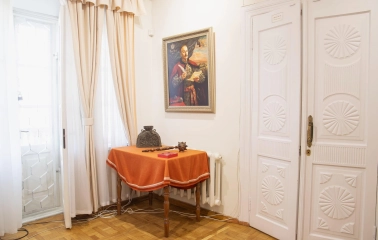 Muzei Hetmanstva in Kyiv - historic interior corner featuring a traditional Cossack mace resting on a table beneath a painted portrait of a Hetman