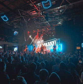 Atlas in Kyiv - vibrant concert atmosphere with blue neon geometric lights on the ceiling and a band on stage