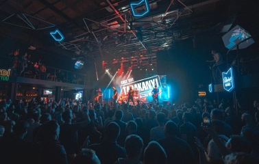 Atlas in Kyiv - vibrant concert atmosphere with blue neon geometric lights on the ceiling and a band on stage