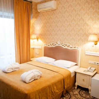 A cozy standard room interior at the Royal Olympic Hotel in Kyiv